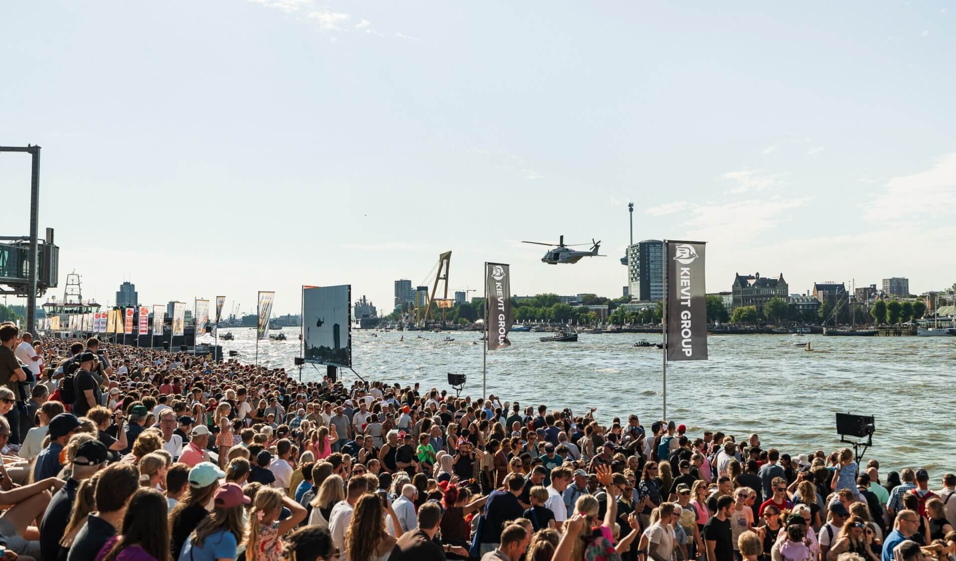 Crowds watching a helicopter demonstration during the World Port Days on the River Maas in Rotterdam.